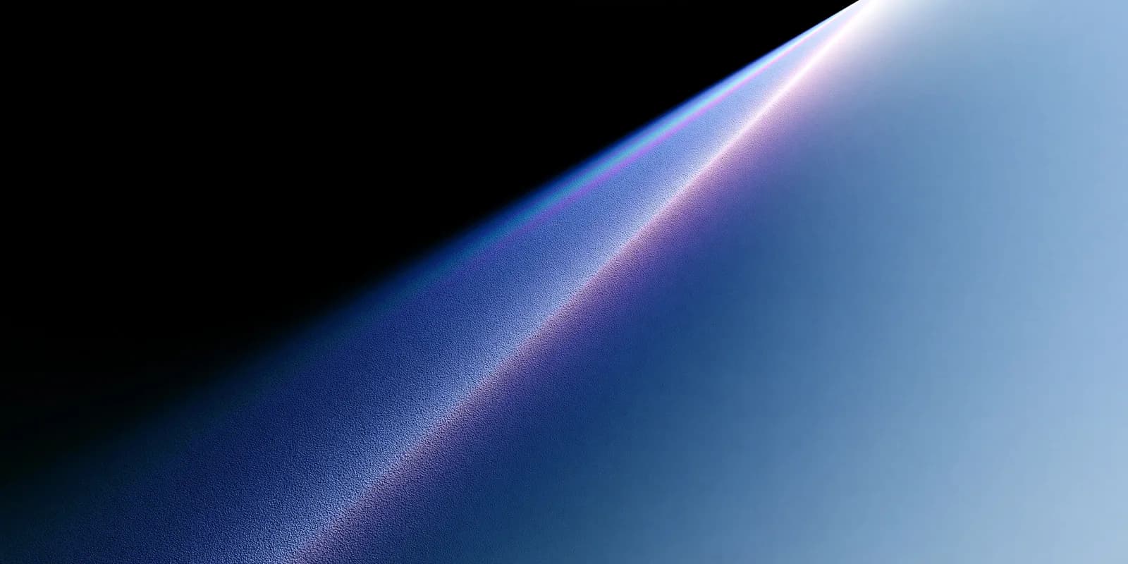 Soft blue and violet light refracting through frosted glass against black.